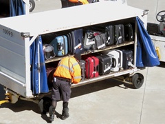 An Airport Baggage Handler Checks Luggage